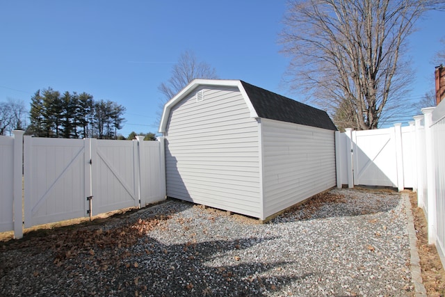 view of shed featuring a gate and a fenced backyard