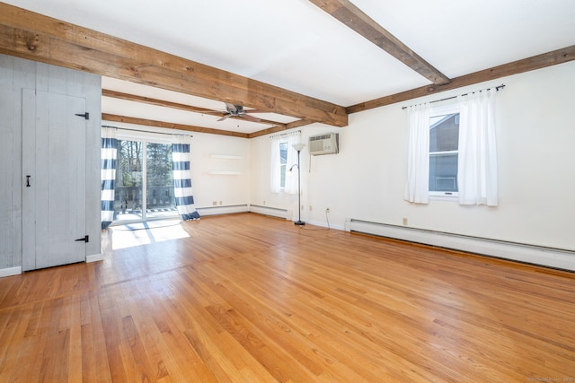 spare room featuring beam ceiling, a wall unit AC, a baseboard heating unit, light wood-style floors, and a ceiling fan