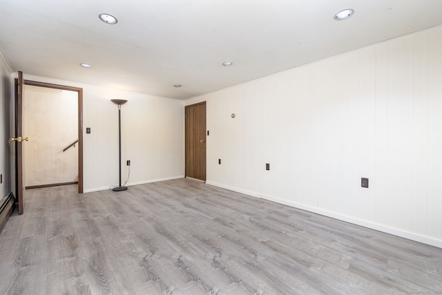 empty room featuring recessed lighting, light wood-style flooring, and baseboards