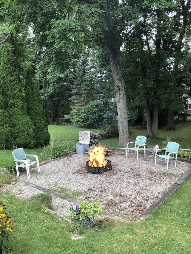 view of yard featuring an outdoor fire pit and a patio area