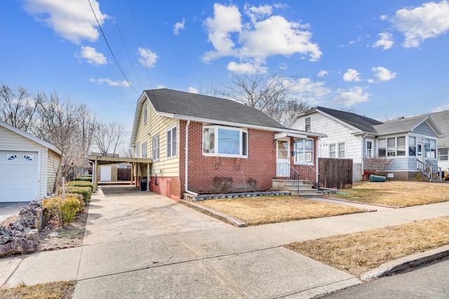 bungalow with a carport, driveway, brick siding, and a shingled roof