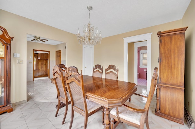 dining room featuring ceiling fan with notable chandelier