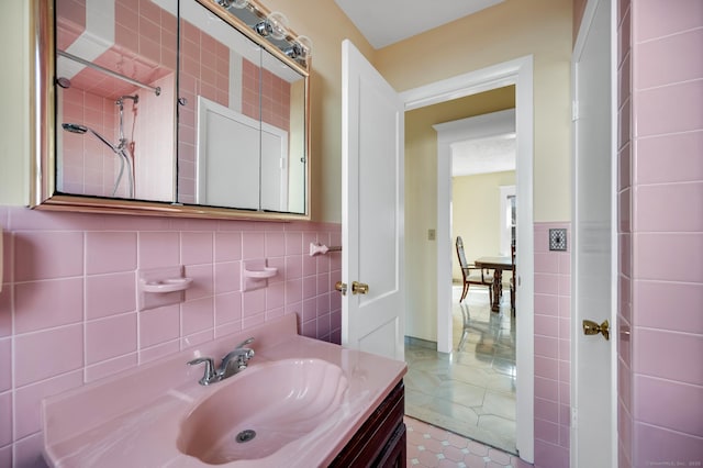 bathroom with wainscoting, tile walls, vanity, and tile patterned floors