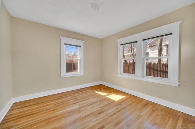 empty room with light wood-style floors and baseboards