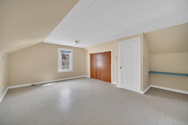 bonus room featuring vaulted ceiling, baseboards, and tile patterned floors