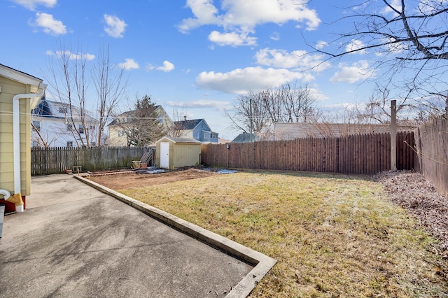 view of yard featuring a patio area, an outdoor structure, a fenced backyard, and a storage shed