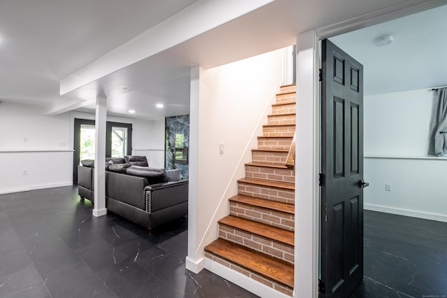 stairs with recessed lighting and baseboards