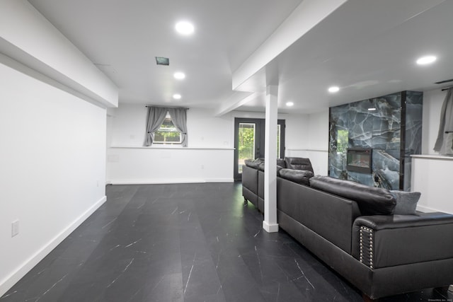 living area with a fireplace, baseboards, and recessed lighting