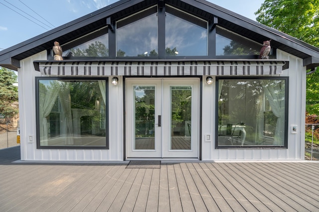 exterior space with french doors, board and batten siding, and a wooden deck