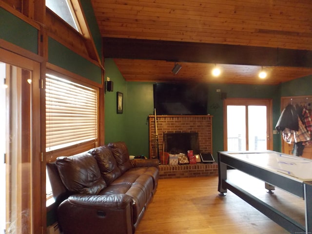 game room featuring a fireplace, wood ceiling, light wood-type flooring, beam ceiling, and rail lighting