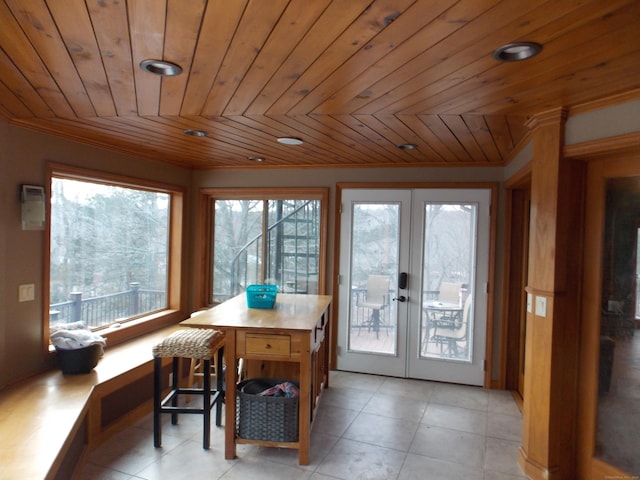 dining space featuring french doors, wooden ceiling, and light tile patterned flooring