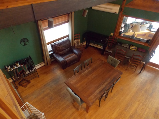 interior space with a wall unit AC and wood finished floors