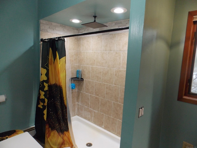 bathroom with a shower stall and recessed lighting