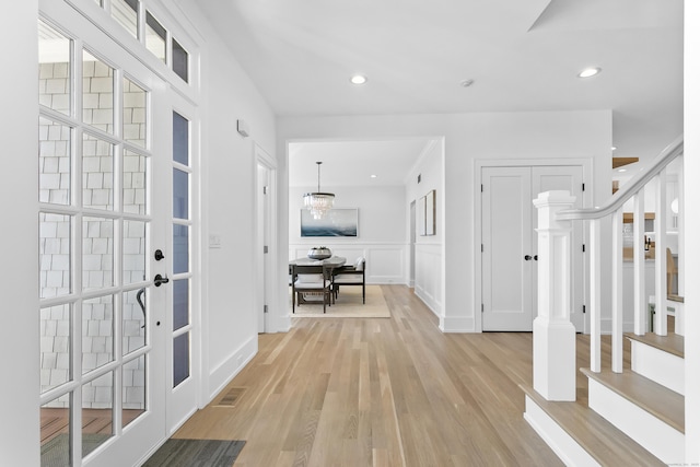 40 Fairfield Beach Rd, Fairfield, CT 06824 - entryway with light wood-style flooring, a decorative wall, a wainscoted wall, recessed lighting, and stairway