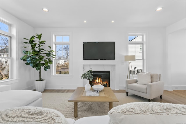 40 Fairfield Beach Rd, Fairfield, CT 06824 - living room featuring recessed lighting, a glass covered fireplace, wood finished floors, and baseboards
