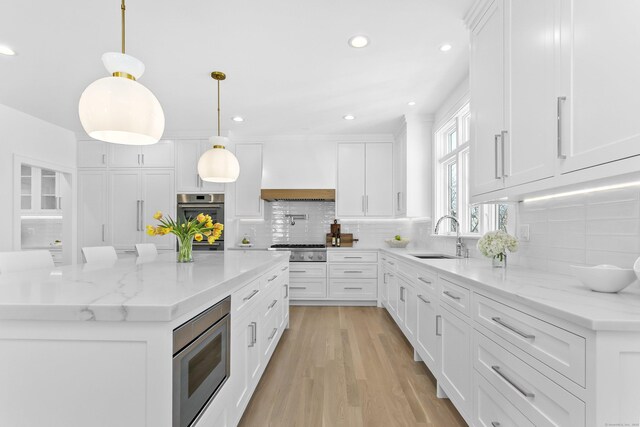 40 Fairfield Beach Rd, Fairfield, CT 06824 - kitchen with stainless steel appliances, a sink, decorative backsplash, white cabinets, and recessed lighting