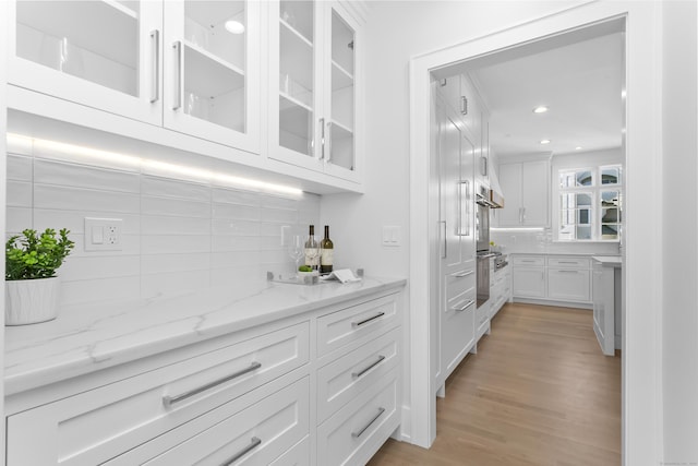 40 Fairfield Beach Rd, Fairfield, CT 06824 - bar featuring tasteful backsplash, stainless steel oven, light wood-type flooring, wall oven, and recessed lighting