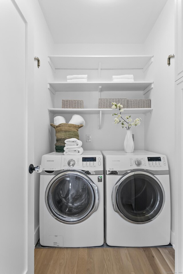 40 Fairfield Beach Rd, Fairfield, CT 06824 - laundry area with washer and clothes dryer and wood finished floors