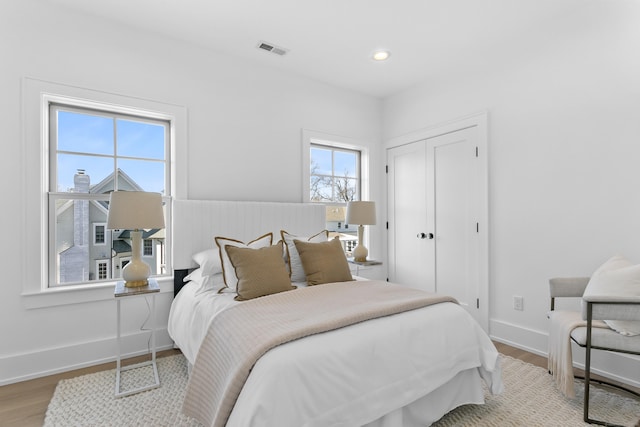 40 Fairfield Beach Rd, Fairfield, CT 06824 - bedroom with wood finished floors, baseboards, a closet, and recessed lighting