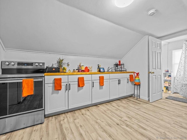 kitchen featuring light wood-style floors, white cabinetry, vaulted ceiling, and stainless steel range with electric cooktop