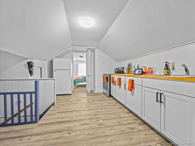 interior space featuring light wood-style floors and lofted ceiling