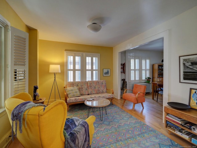 living room with radiator and wood finished floors