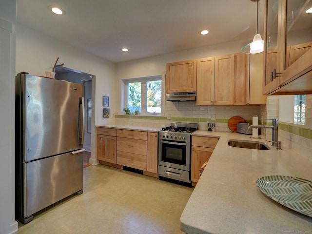 kitchen featuring stainless steel appliances, light countertops, under cabinet range hood, and light brown cabinetry