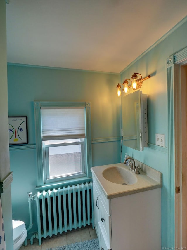 half bath with toilet, radiator heating unit, tile patterned flooring, and vanity