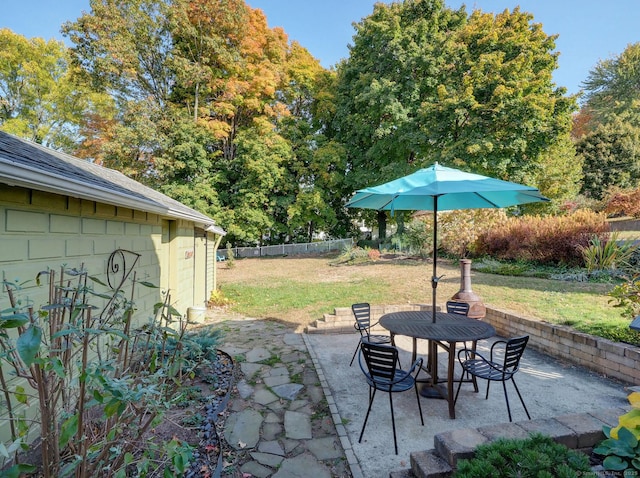 view of patio featuring outdoor dining area and fence