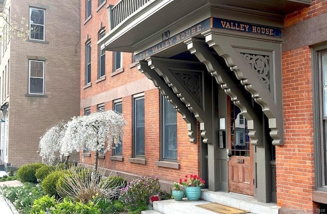 entrance to property with brick siding