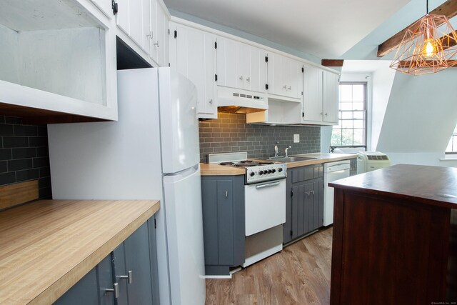 kitchen featuring hanging light fixtures, white appliances, under cabinet range hood, and white cabinetry