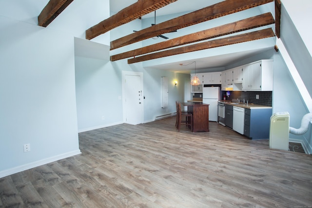 kitchen with open floor plan, a center island, decorative light fixtures, light countertops, and white cabinetry