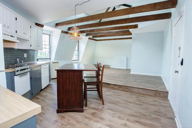 kitchen with a center island, white cabinets, light countertops, and decorative light fixtures