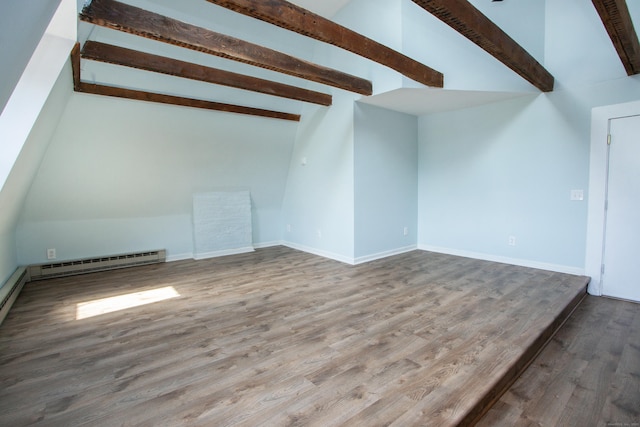 additional living space featuring vaulted ceiling with beams, a baseboard radiator, wood finished floors, and baseboards