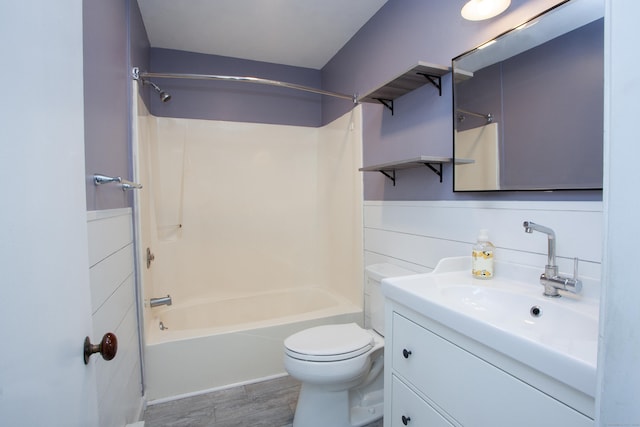 full bathroom with  shower combination, toilet, wood finished floors, and vanity