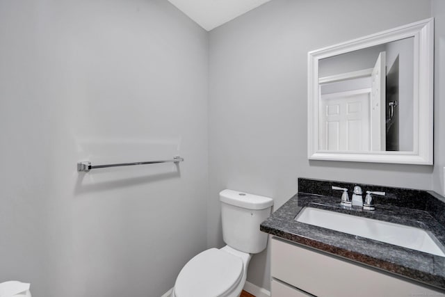 bathroom with toilet and vanity