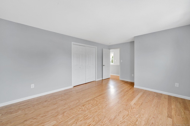 unfurnished room featuring light wood-style flooring and baseboards