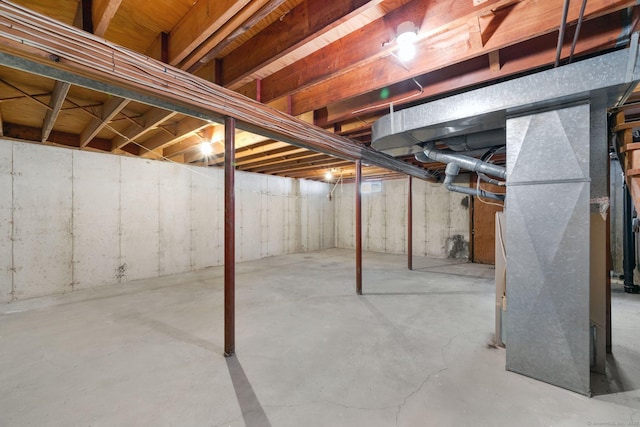 unfinished basement featuring heating unit