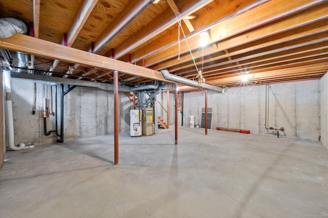 unfinished basement featuring gas water heater