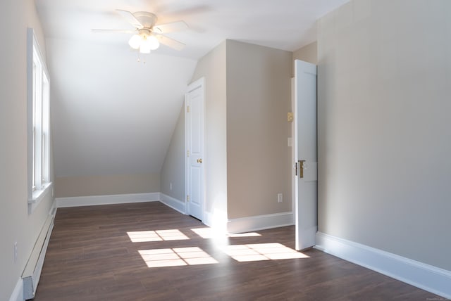 bonus room featuring baseboard heating, vaulted ceiling, ceiling fan, wood finished floors, and baseboards