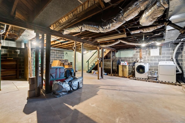 unfinished basement with stairs, heating fuel, and washer and dryer