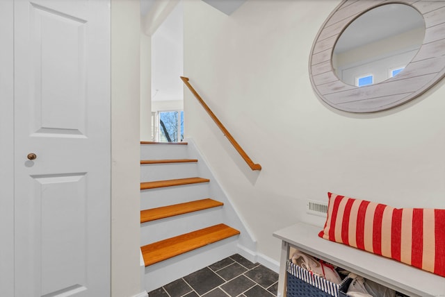 stairway with tile patterned flooring and baseboards