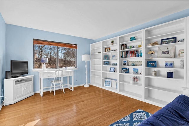 living area featuring light wood-type flooring and baseboards