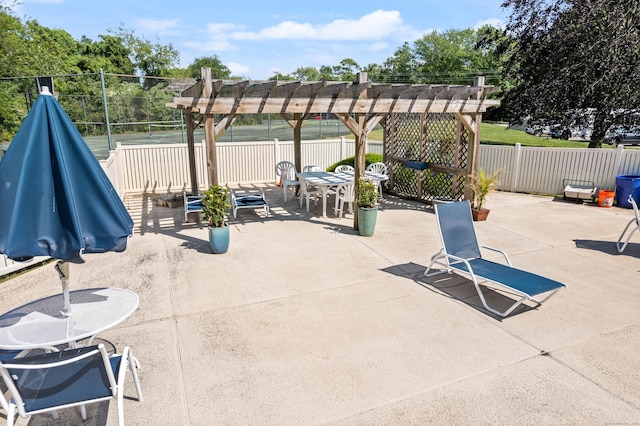 view of patio featuring outdoor dining area, fence, and a pergola