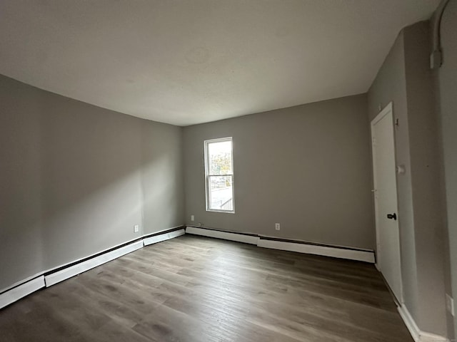 unfurnished room with wood finished floors