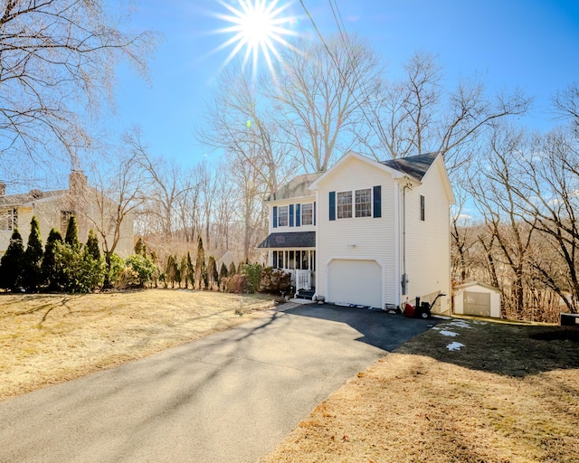 view of front of property with aphalt driveway and an attached garage