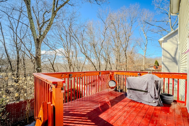 wooden terrace with fence and area for grilling