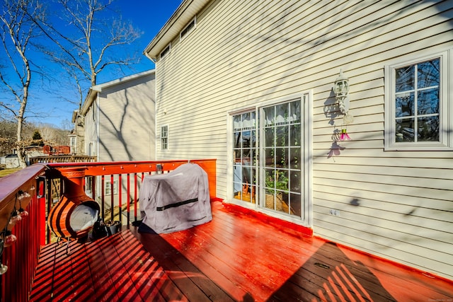 wooden terrace featuring grilling area