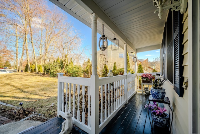 wooden terrace with a porch and a lawn