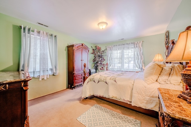 bedroom featuring carpet flooring and visible vents